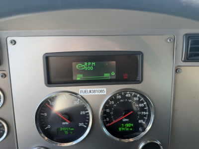 Dashboard panel of a 2023 Kenworth T270 showing RPM gauge and speedometer with digital displays and a small screen at top displaying RPM and status icons.