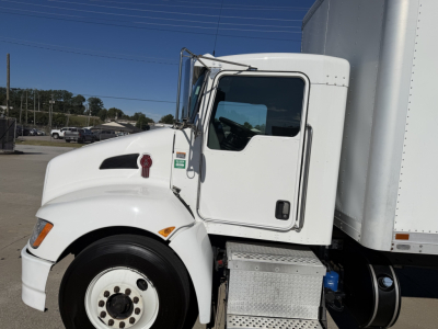 Truck cab side view showing Kenworth T270, front wheel, white exterior, door handle, side mirror, and cab entry with steps.