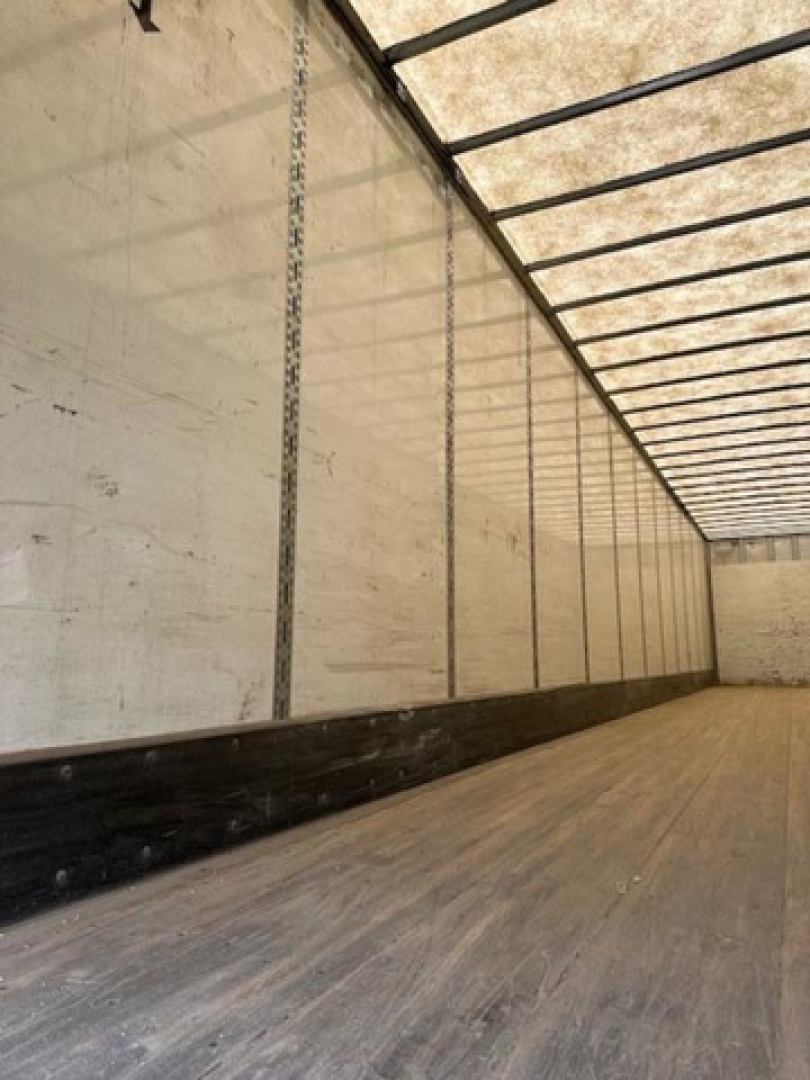 Interior of a used 2014 Wabash van trailer with empty cargo area and wooden floor, no visible branding or labels readable.