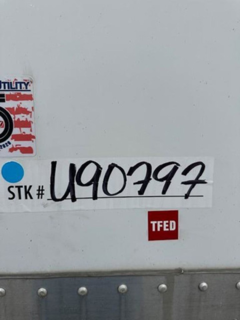 Stock sticker and TFED label on a Wabash van trailer showing STK # U90797, TFED badge, and utility sticker.