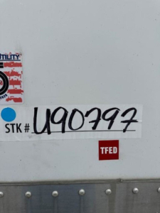 Stock sticker and TFED label on a Wabash van trailer showing STK # U90797, TFED badge, and utility sticker.