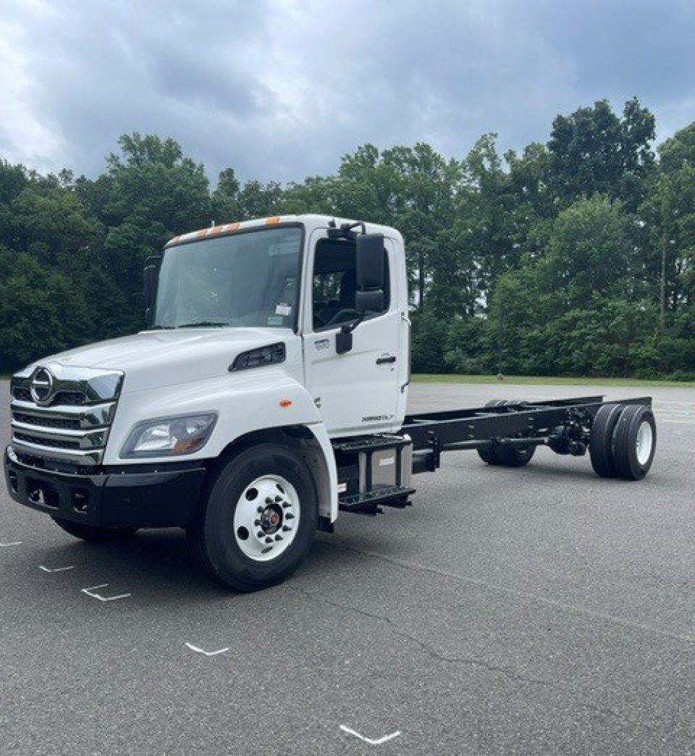 White 2027 Hino L7 cab chassis truck with empty rear frame, side view showing cab details and front grille.