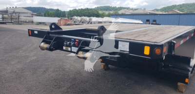 Flatbed trailer showing rear view with ramp, deck, and hydraulic system; Fontaine Renegade X20 trailer details visible on front plate area
