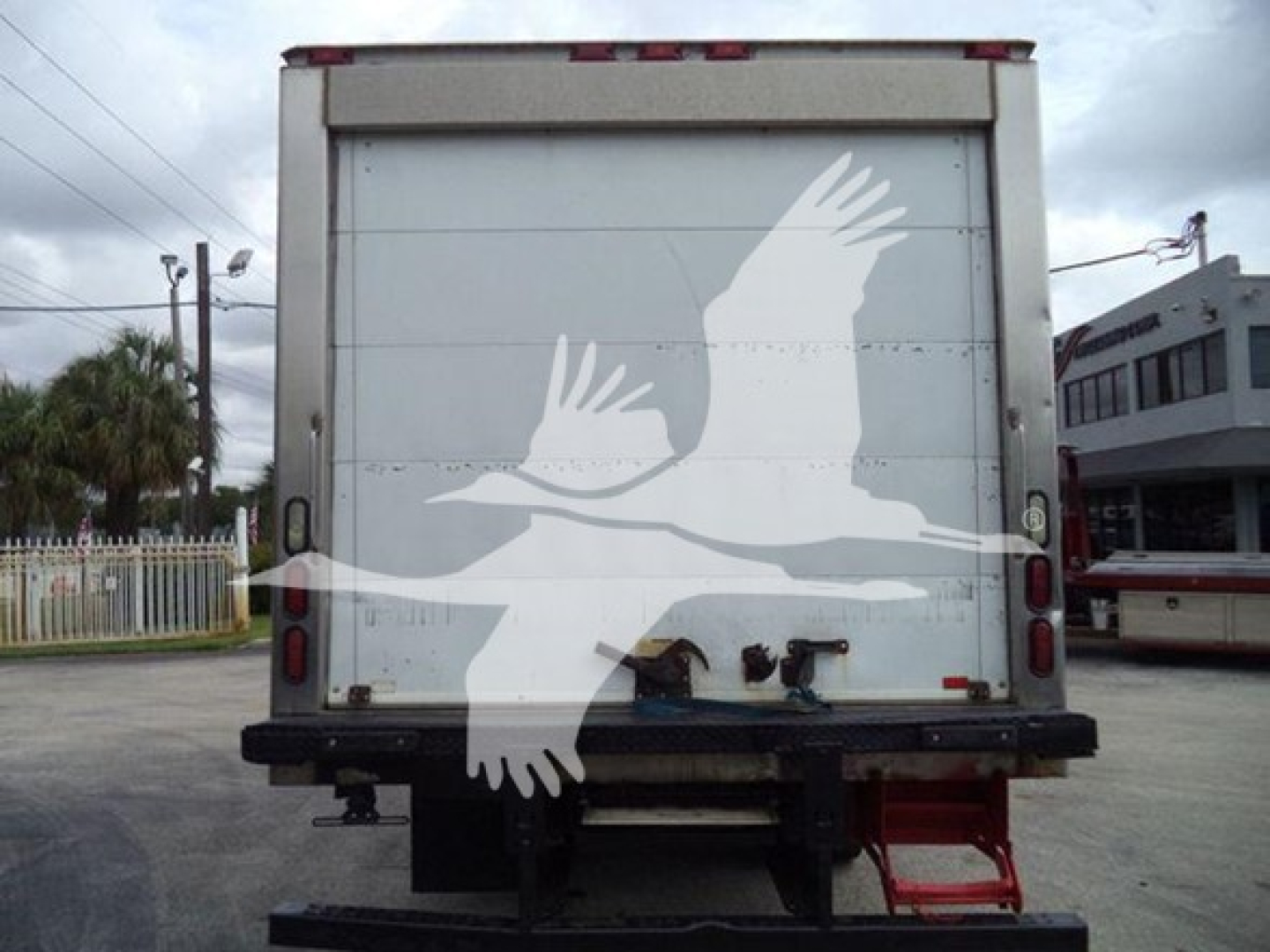 Rear view of a refrigerated truck box on a 2019 Hino 195 with doors and rear bumper visible.