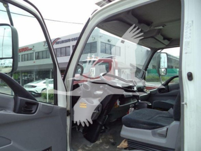 Cabin interior of a 2019 Hino 195 refrigerated truck showing open driver door, steering wheel, dashboard, and front seat.
