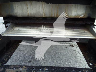 Refrigerated truck step area showing metal threshold and lower step with signs of use beneath a cargo floor.