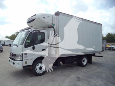 2019 Hino 195 refrigerated truck with a white cab and a large insulated box, branding on side, refrigeration unit on top front, side view.