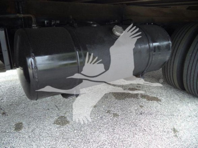 Tank trailer or refrigeration unit cylinder underframe showing black cylindrical tank with exposed fittings and wheels nearby.