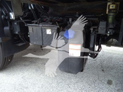 Hino 195 refrigerated truck undercarriage showing battery box and fluid reservoir with clutter and wiring visible.