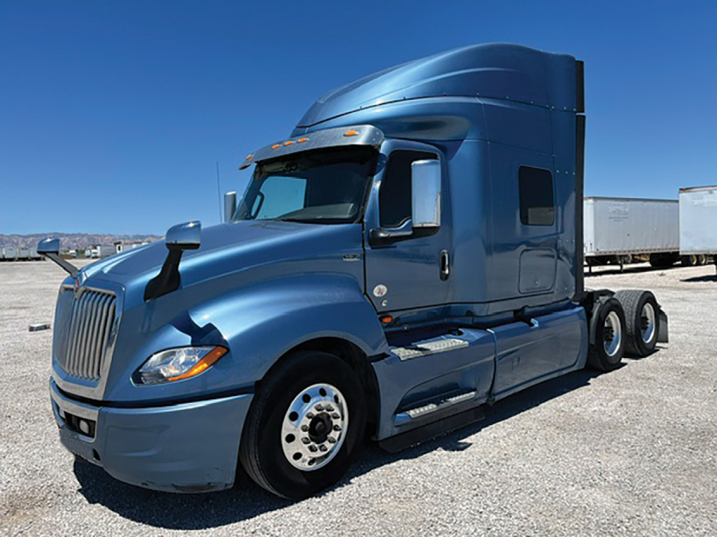 Blue 2019 International LT625 conventional sleeper truck showing front grille, cab, and dual rear axles.