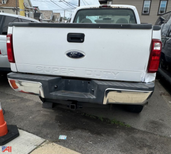 Ford F-350 Super Duty tailgate with emblem, rear bumper, and hitch visible.