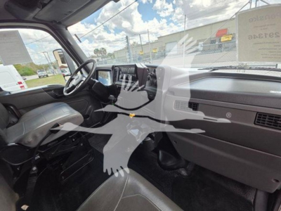 Interior view of a 2020 International MV cab showing steering wheel, dashboard, and front seats.