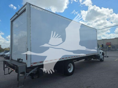 Box truck showing side view with white cargo box and rear wheels.