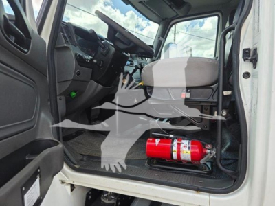 Cab interior of a 2020 International MV truck showing dash, steering wheel, and a red fire extinguisher in the doorway area.