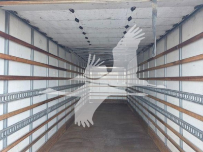 No image of the truck engine; image shows empty trailer interior with overhead lighting and side rails.