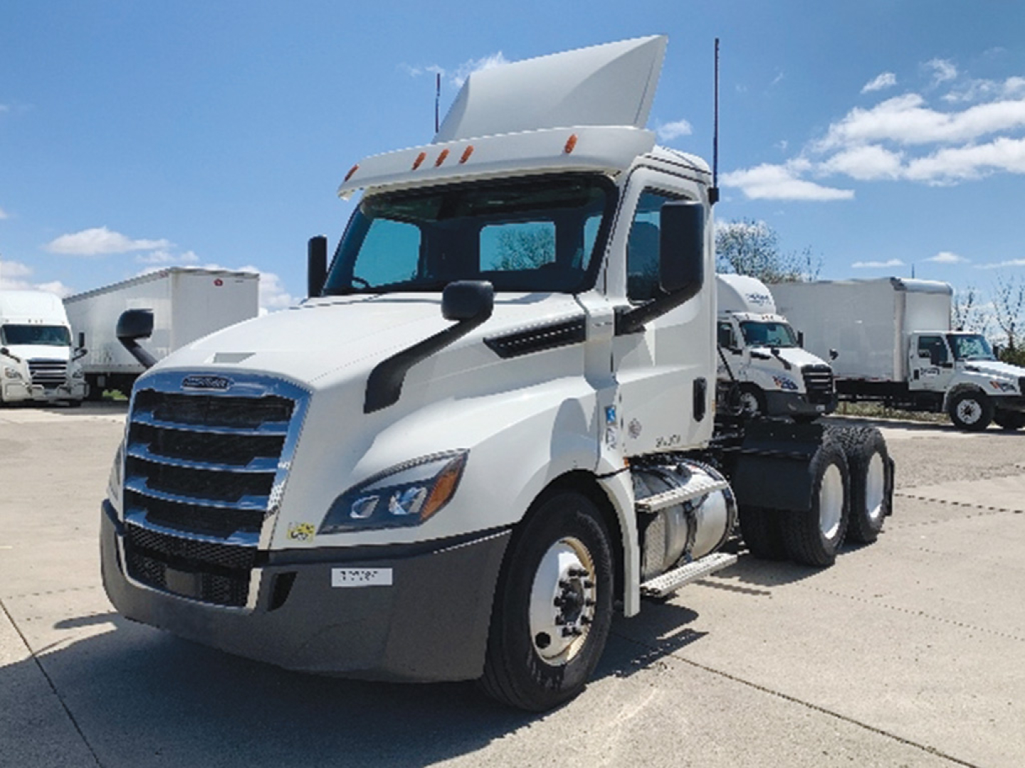 Freightliner Cascadia126 tractor in a parking lot from a front-left view showing the cab and raised sleeper.