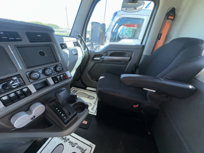 Cab interior of a 2018 Kenworth T880 showing dashboard controls, steering column, center console, and driver seat.
