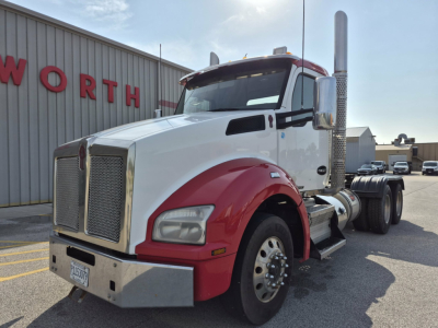 Kenworth T880 conventional daycab truck in white and red with chrome exhaust stacks, front grille, and dual rear axles.