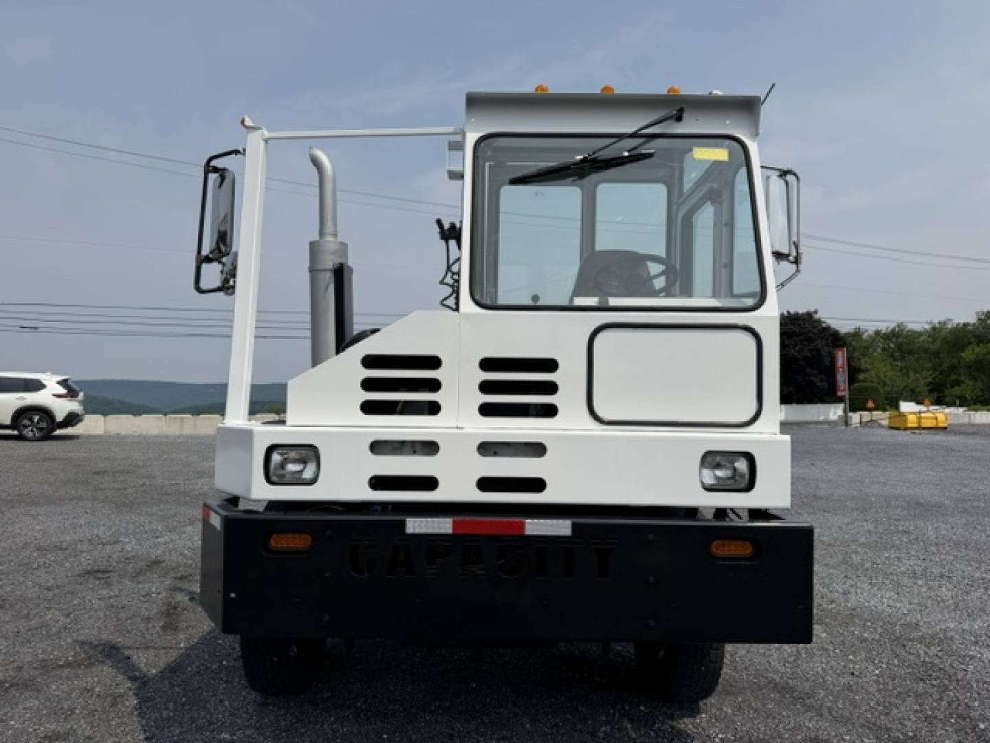 Capacity TJ5000 yard truck front view showing cab, grille vents, and solid front bumper.