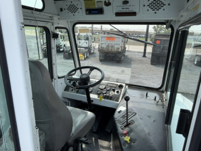 Cab interior of a 2012 Capacity TJ5000 truck showing steering wheel, dashboard with gauges, and control levers.
