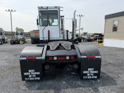 Rear view of a Capacity TJ5000 truck tractor showing dual rear fenders and back of cab; visible text on mudflaps reads 'BEST USED TRUCKS OF PA' with phone number.