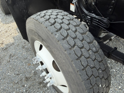 Capacity TJ5000 wheel and tire visible, heavy-duty truck axle and lug nuts in view.