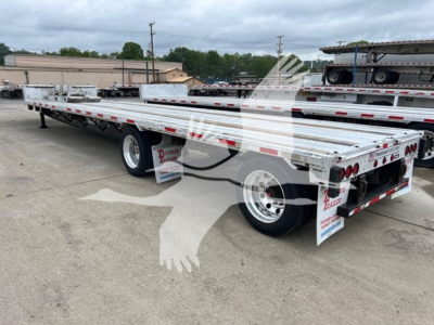 Trailer showing flatbed deck rails and rear hydraulic suspension with dual rear axles and mud flaps. Visible markings include stock number 7645 and Texas trailer branding on mud flaps.