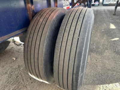 Tandem axle trailer wheels showing four-steel belt tires with no visible tread on Fontaine Infinity trailer.