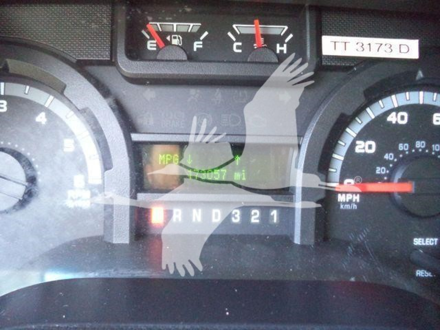 Ford E450 dashboard with speedometer and gauges, showing mileage and gear indicator; visible text includes MPG and PRND321 gear display.
