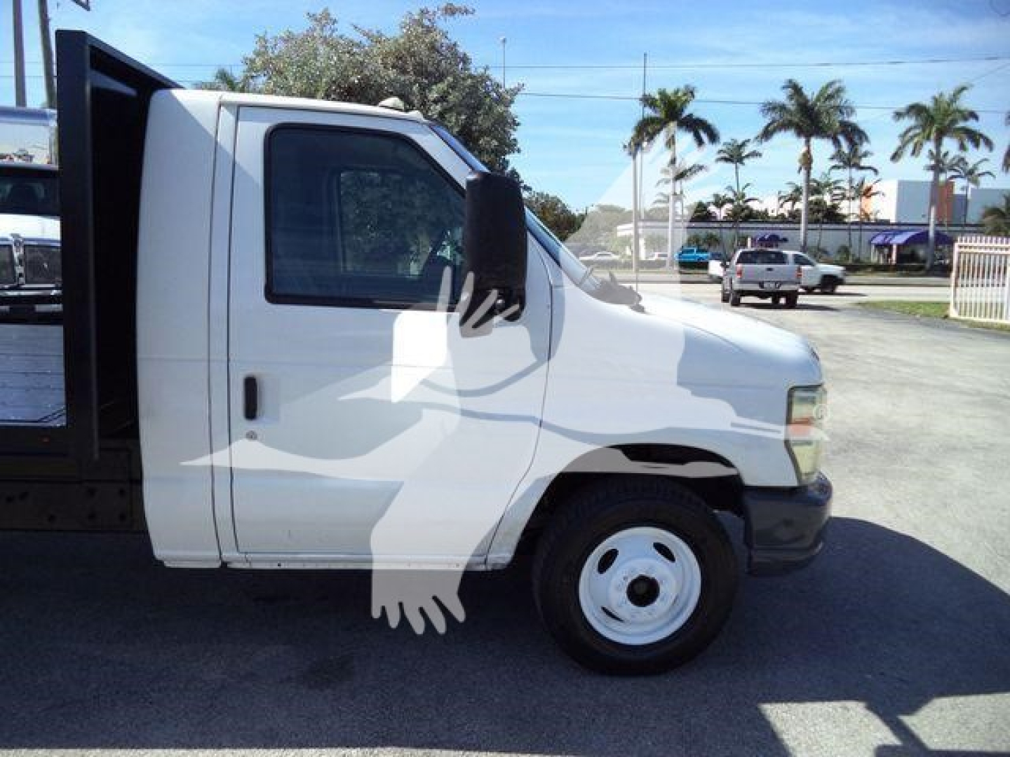 Ford E-Series truck side view showing flatbed tow body and front cab, white exterior, single rear wheel visible, stock number T22070FM.