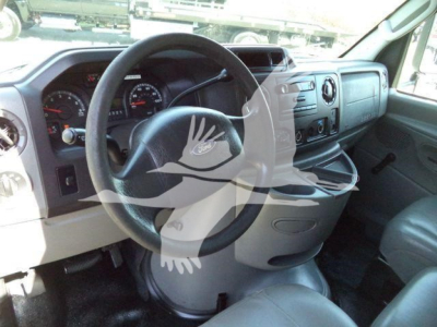 Ford E-450 dashboard and steering wheel in-cab view; visible gauges and console; watermark overlay on windshield.