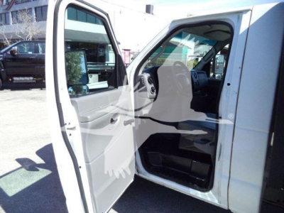 Ford E-450 cargo van side and door open showing interior cab and front passenger area.