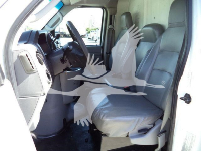 Ford E-450 van interior showing front seats and dashboard view from open driver door.