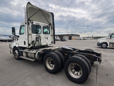 Truck chassis and cab of a 2020 Freightliner Cascadia 116 used tractor with sleeper cab and dual rear axles showing the fifth wheel area and rear wheels.