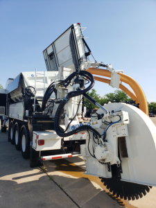 Volvo VHD86B300 trenching truck with large auger attachment and hydraulic hoses visible.