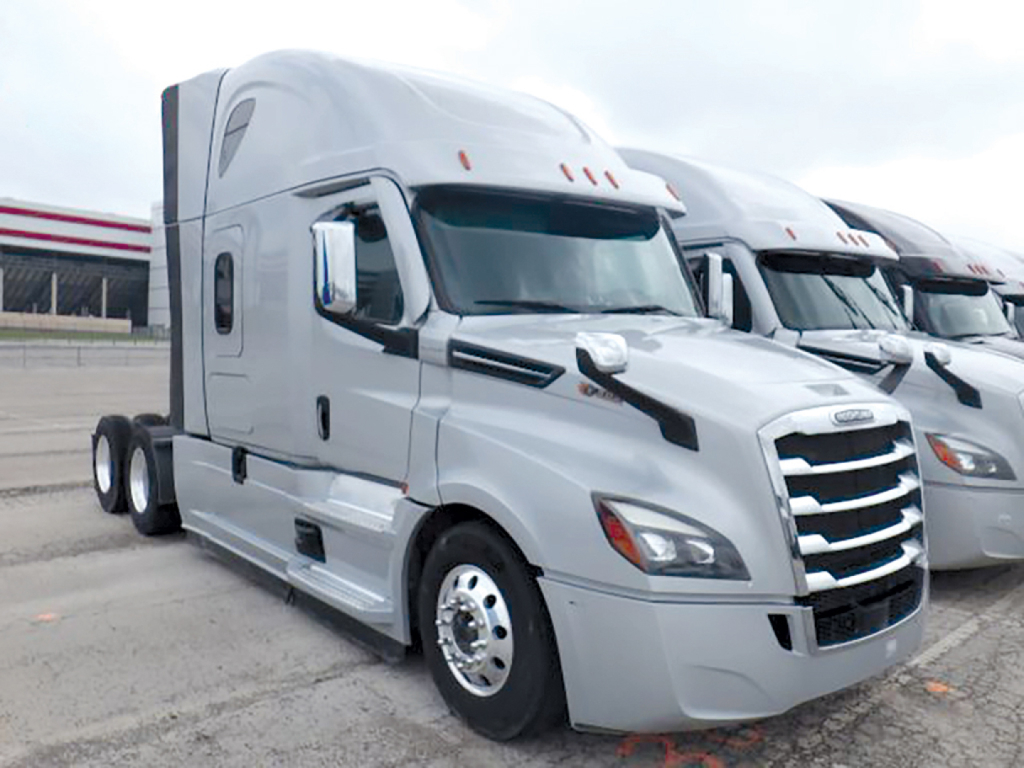 Freightliner Cascadia126 sleeper cab truck in view showing front grille and side profile