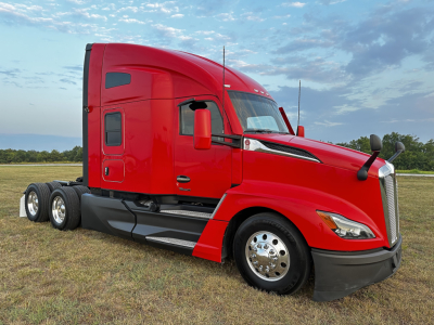 Red Kenworth T680 tractor-trailer cab, side view, with dual rear axles and chrome wheels.
