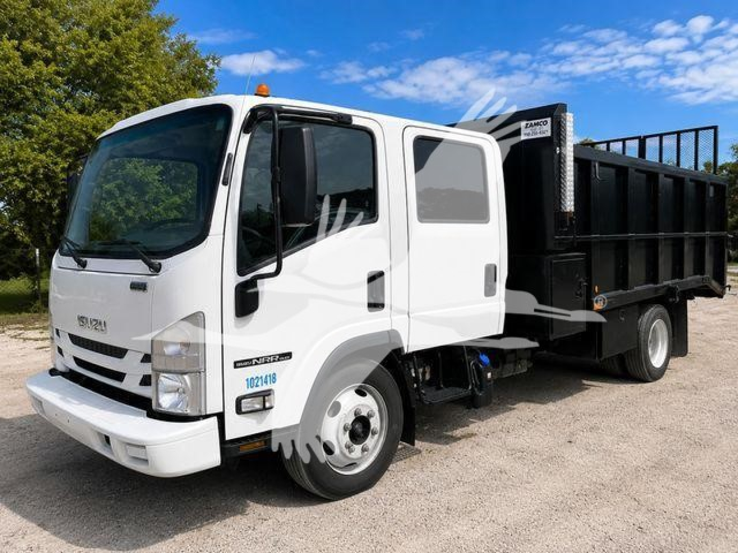 Isuzu NPR-HD dump truck with white cab and black dump bed, side view showing front and passenger side.