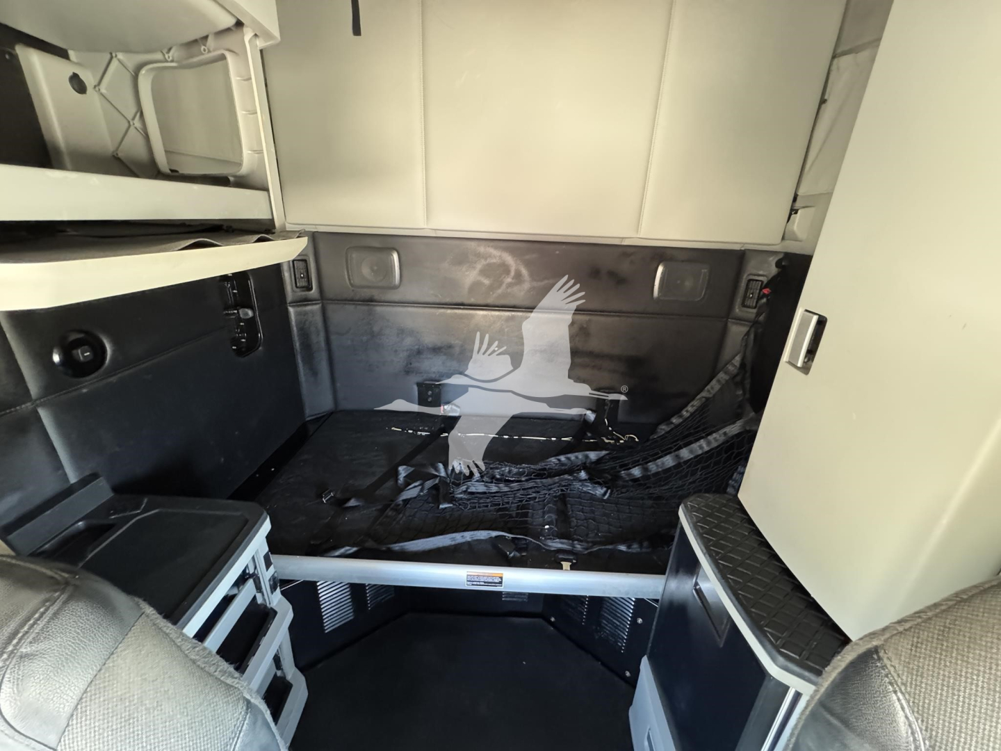 Kenworth T680 sleeper cab interior cargo area with metal walls and storage compartments visible.