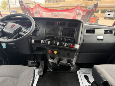 Kenworth T680 cabin interior view with steering wheel, dashboard, and center console.