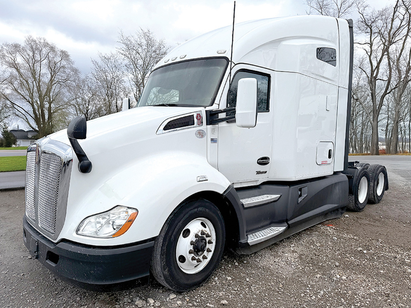 Kenworth T680 conventional sleeper truck in white, side view showing cab, front grille, headlights, and dual rear axles.