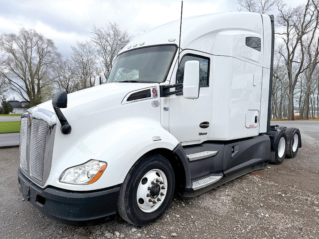 Kenworth T680 conventional sleeper truck in white, side view showing cab, front grille, headlights, and dual rear axles.