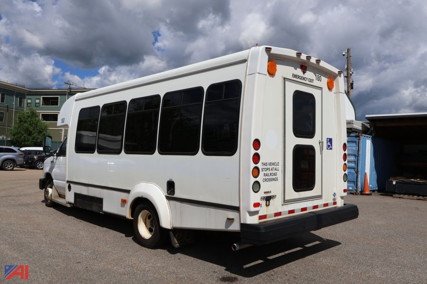 2019 Ford E450 wheelchair bus rear three-quarter view showing side windows and rear doors with ADA sign