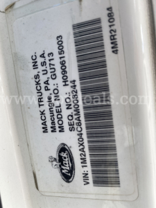 Label showing VIN, model and manufacturer data on Mack Trucks: 'MACK TRUCKS, INC. Macung, PA USA', model GU713, SEQ/SEQ No. H0090615003, VIN 1M2AX04C8AM008244, bar code.