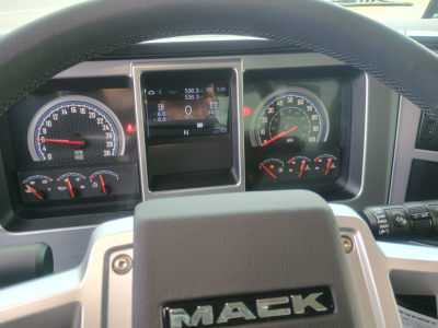Mack GR84F dashboard and instrument cluster showing speedometer, tachometer, and digital display in center console.