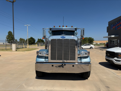 Peterbilt 389 dump truck front view showing large grille and chrome bumper.