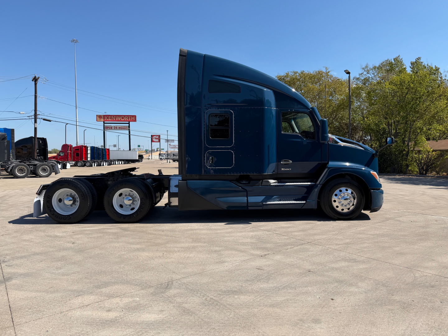 Kenworth T680 tractor-trailer side view showing blue sleeper cab and 6x4 wheel configuration, stock number 0630694, VIN 1XKYDP9X4PJ222226.