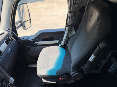 Cab interior of a Kenworth T680 truck showing the driver seat and part of the dash; no visible model badges or numeric specifications in the image.