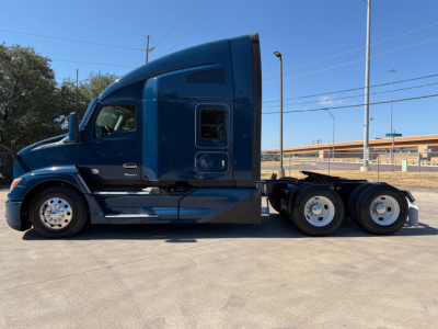 Kenworth T680 tractor trailer side view showing blue cab and rear axle configuration.