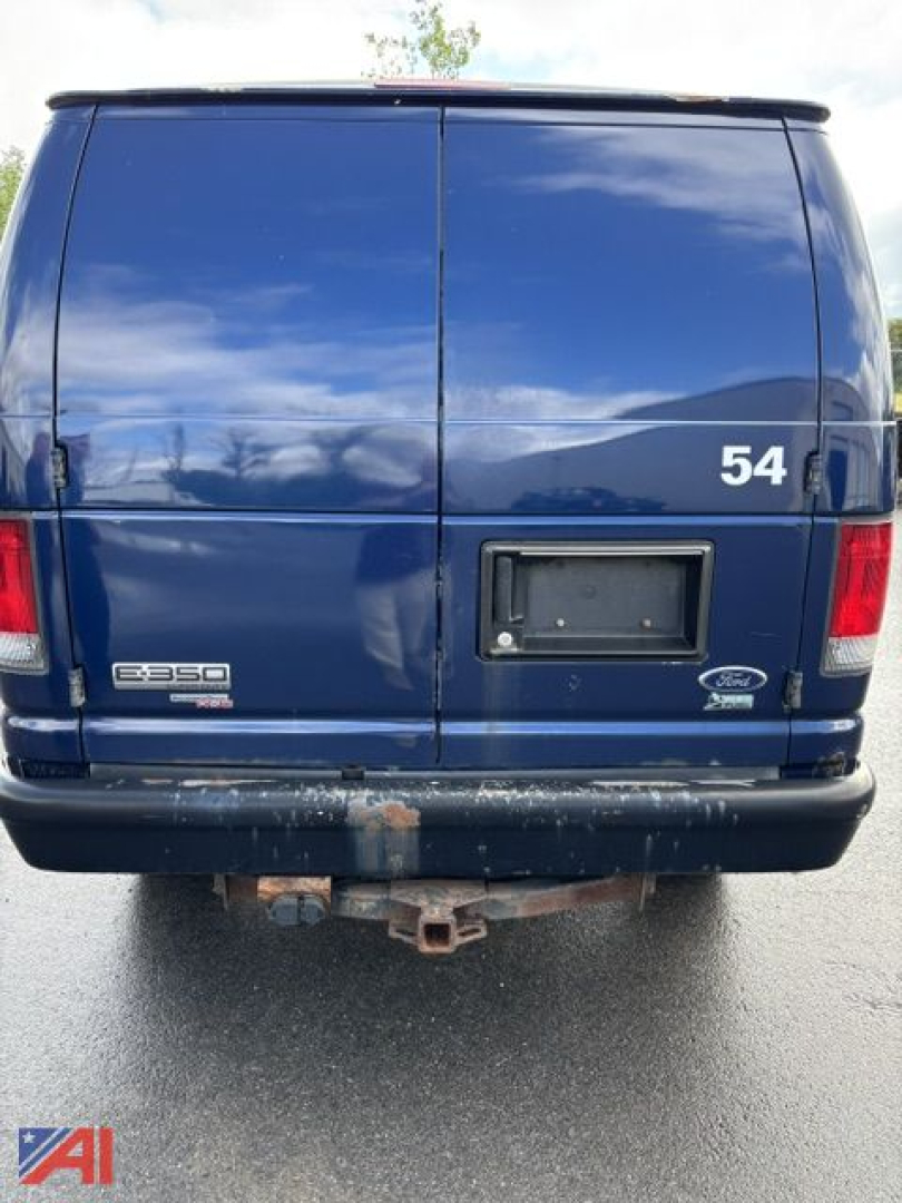 Ford E-350 cargo van rear view showing twin rear doors, E-350 badge, Ford logo, and bumper with hitch receiver.